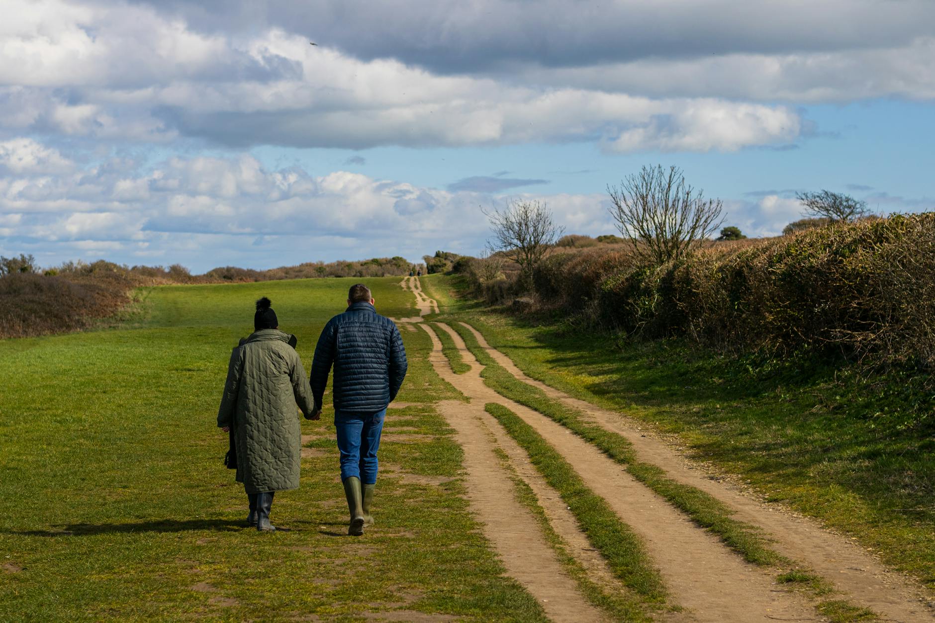 Agroturystyka tylko dla dorosłych: gdzie jechać, gdy chcesz ciszy i prywatności Para zakochanych trzymająca się za ręce na spacerze wśród zieleni